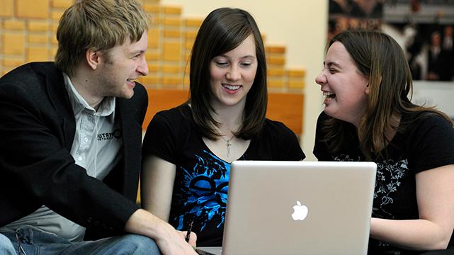 three students on computer