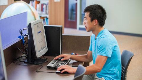 Student at computer in Library